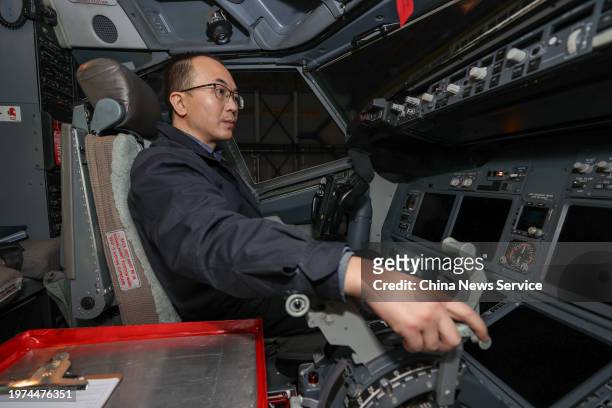 Mechanical engineer debugs the cockpit of a passenger plane at a maintenance base of China Southern Airlines to ensure the safety of flight...