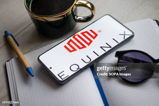 In this photo illustration an Equinix logo seen displayed on a smartphone.