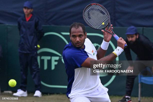 India's Ramkumar Ramanathan hits a return against Pakistan's Aisam-ul-Haq Qureshi during the Davis Cup World Group-1 Play-offs between Pakistan and...