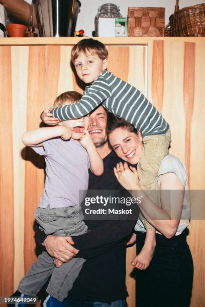 playful family having fun with each other while standing at home - flash stock-fotos und bilder