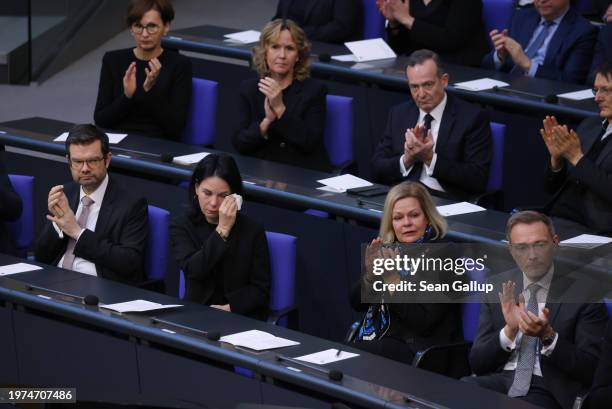 Members of the German government cabinet, including visibly moved Foreign Minister Annalena Baerbock wiping a tear from her eye, listen to Holocaust...