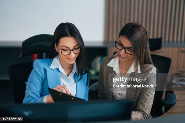 colleagues sharing plan, report, data, stats, content in the office at work - dress code stock pictures, royalty-free photos & images