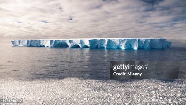 gigantic tabular iceberg natural arches antarctic ocean antarctica - tabular iceberg stockfoto's en -beelden