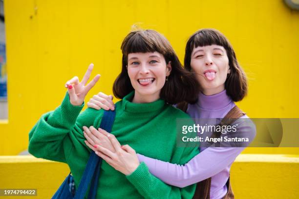 friends making peace sign and sticking tongue out - fashion suit stock pictures, royalty-free photos & images