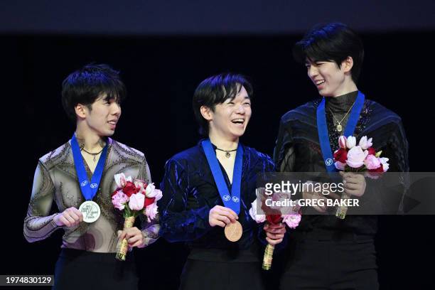 Japan's Yuma Kagiyama celebrates on the podium after winning the men's competition at the ISU Four Continents Figure Skating Championships, with...