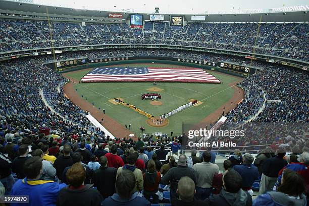 Fans stand at attention during the national anthem before the home opener between the Philadelphia Phillies and the Pittsburgh Pirates at Veterans...