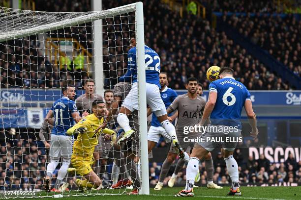 Everton's English defender James Tarkowski heads the ball before Everton's English striker Dominic Calvert-Lewin scores the equaliser during the...