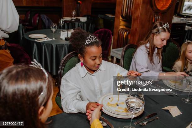 table etiquette lesson in the restaurant. - polite girl stock pictures, royalty-free photos & images