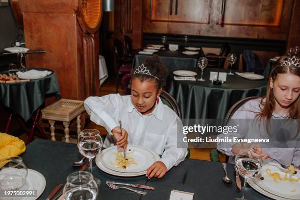table etiquette lesson in the restaurant. - polite girl stock pictures, royalty-free photos & images
