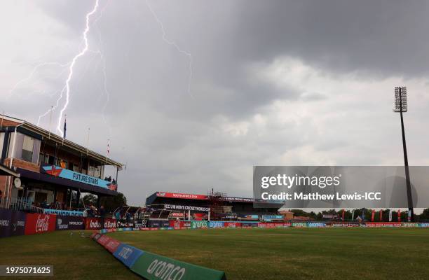 Lightning is seen overhead as adverse weather delays play during the ICC U19 Men's Cricket World Cup South Africa 2024 Super Six match between...