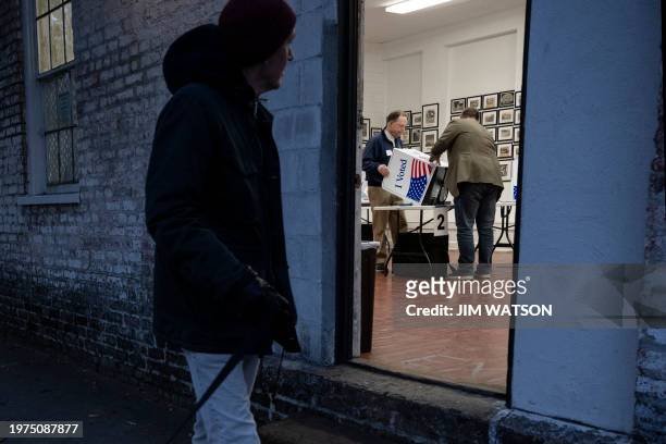 Poll managers set up voting machines as voters begin to arrive at polling location in Charleston, South Carolina, on February 3 during the South...