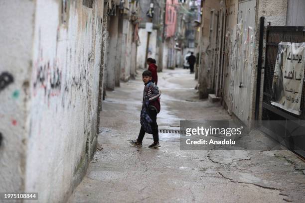 People walk in narrow streets at al-Am'ari Refugee Camp after funding cuts to UNRWA in Ramallah, West Bank on February 03, 2024. Last week, countries...