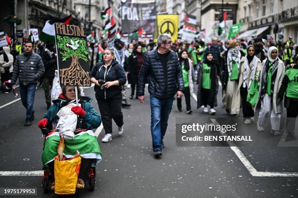 Pro-Palestinian activists and supporters wave flags, chant slogans and carry placards during a National March for Palestine, in central London, on...