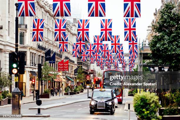 regent street decorated with british flags, london, england, uk - high street stock-fotos und bilder