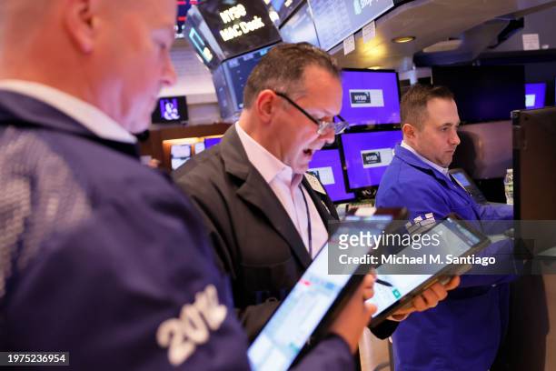 Traders work on the floor of the New York Stock Exchange during morning trading on January 31, 2024 in New York City. Stocks opened up mixed with the...