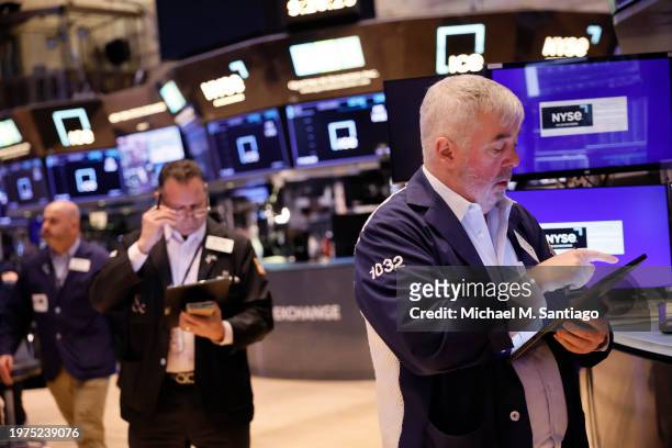 Traders work on the floor of the New York Stock Exchange during morning trading on January 31, 2024 in New York City. Stocks opened up mixed with the...