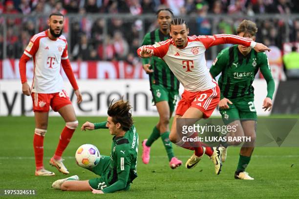 Bayern Munich's German forward Leroy Sane and Moenchengladbach's German midfielder Florian Neuhaus vie for the ball during the German first division...