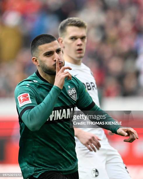 Stuttgart's German forward Deniz Undav celebrates scoring his team's first goal next to Freiburg's German defender Matthias Ginter during the German...