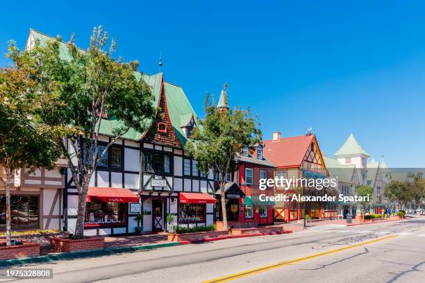 street with colourful danish style buildings in solvang town, california, usa - solvang stock pictures, royalty-free photos & images