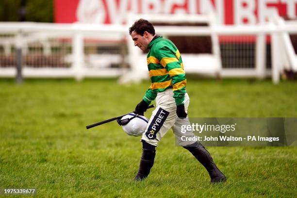 Jockey Jonathan Burke walks back in after being unseated by In Excelsis Deo during the Virgin Bet Every Saturday Money Back Handicap Chase during the...