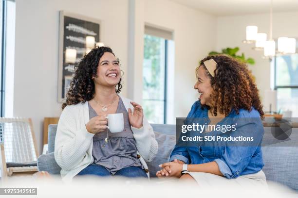 adult daughter gestures while talking to her mom - sister stock pictures, royalty-free photos & images