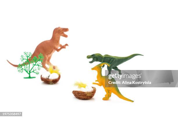 toy dinosaurs near nest with eggs on white background - dinosaur background stock pictures, royalty-free photos & images