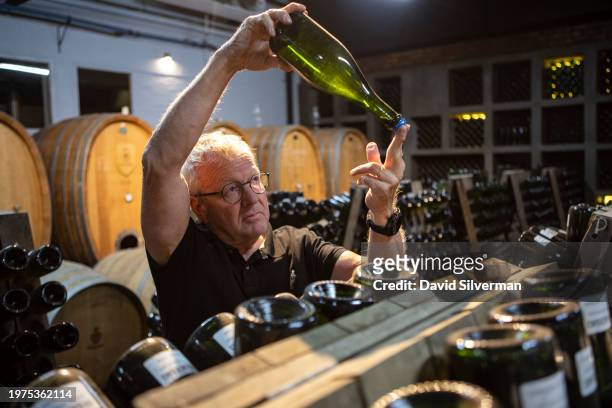 Winemaker Pieter Ferreira checks up on aging Cap Classique sparkling wine at the Graham Beck Estate winery on January 24, 2024 near Robertson in...
