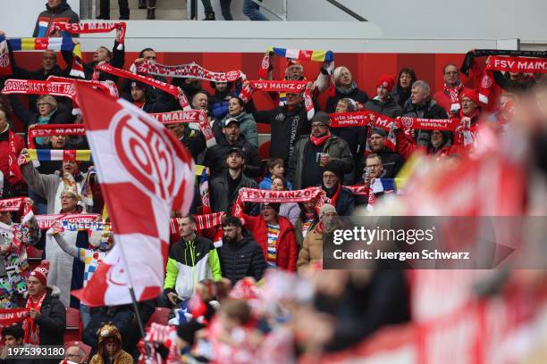 Supporters of Mainz celebrate carnival when they support their team during the Bundesliga match between 1. FSV Mainz 05 and SV Werder Bremen at MEWA...