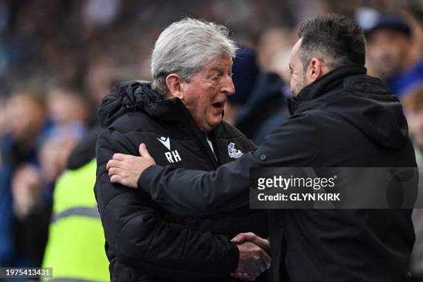 Brighton's Italian head coach Roberto De Zerbi and Crystal Palace's English manager Roy Hodgson shake hands prior to the English Premier League...