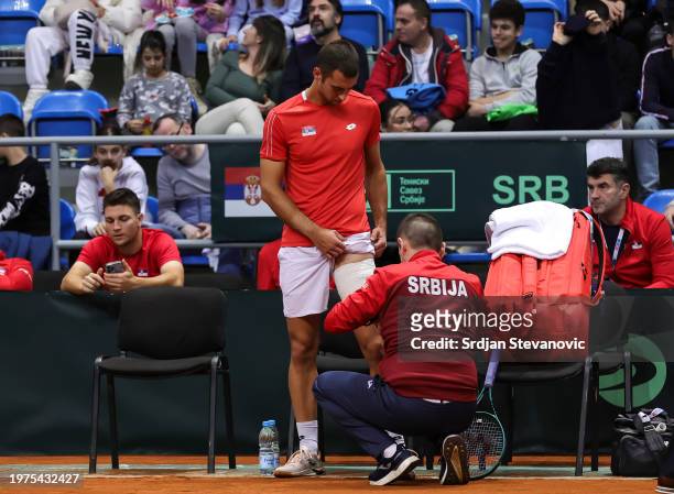 Laslo Djere of Serbia receive medical help during his match against Lukas Pokorny of Slovakia on day 2 of the Davis Cup Qualifier match between...