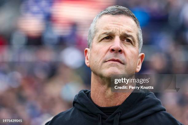 John Harbaugh of the Baltimore Ravens looks on from the sideline during the national anthem prior to the AFC Championship NFL football game against...