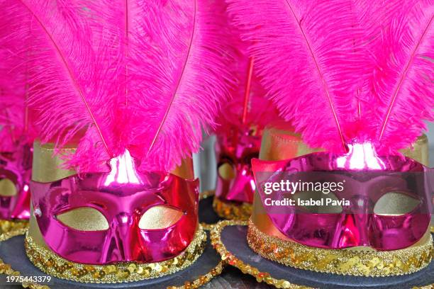 carnival hats and masks on table - gold streamer stock pictures, royalty-free photos & images