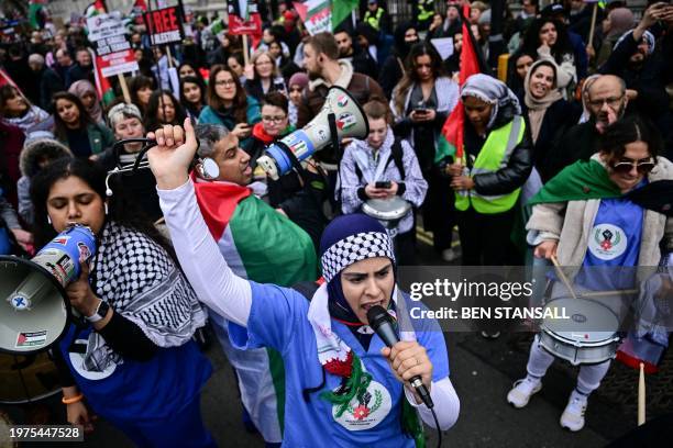 Pro-Palestinian supporter chants slogans in a microphone as she takes part in a National March for Palestine in central London on February 3, 2024....