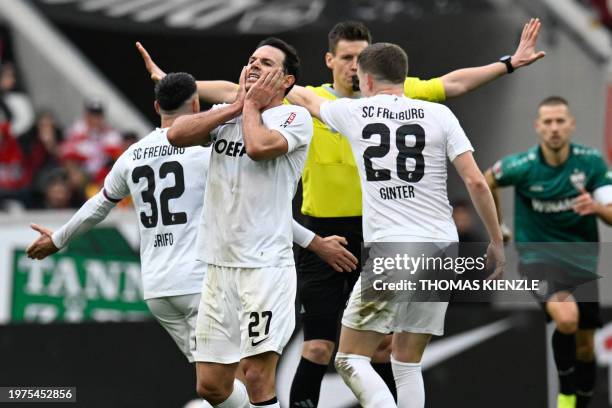 Freiburg's German midfielder Nicolas Hoefler and Freiburg's German defender Matthias Ginter react after a decision by the referee during the German...