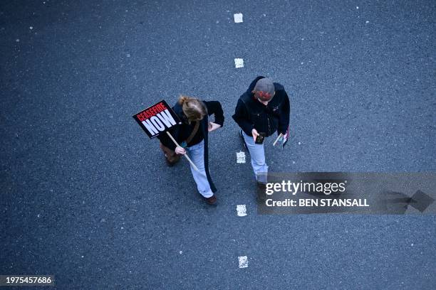 Pro-Palestinian supporters carry placards during a National March for Palestine in central London on February 3, 2024. Deadly strikes were reported...