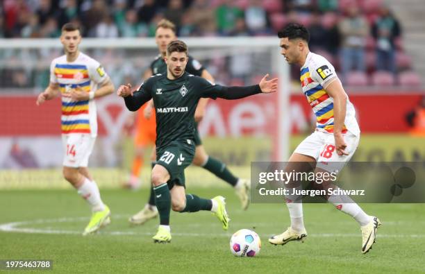 Romano Schmid of Bremen and Nadim Amiri of Mainz compete during the Bundesliga match between 1. FSV Mainz 05 and SV Werder Bremen at MEWA Arena on...