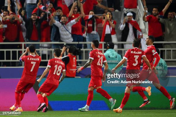 Omar Khrbin of Syria celebrates scoring their first goal during the AFC Asian Cup Round of 16 match between Iran and Syria at Abdullah Bin Khalifa...