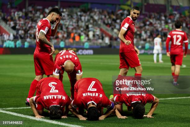 Omar Khrbin of Syria celebrates his goal with teammates during the AFC Asian Cup Round of 16 match between Iran and Syria at Abdullah Bin Khalifa...