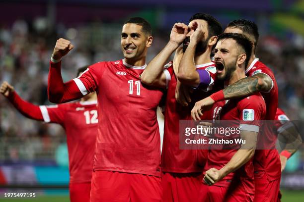 Omar Khrbin of Syria celebrates his goal with teammates during the AFC Asian Cup Round of 16 match between Iran and Syria at Abdullah Bin Khalifa...
