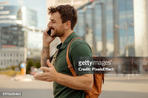 Man With Smartphone in Hand Browsing Social Media on the Street