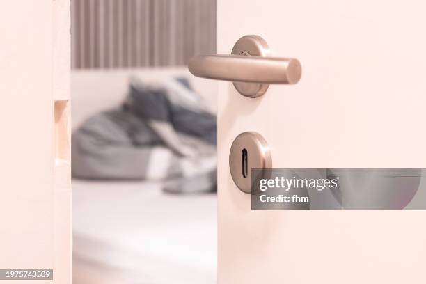 open door with secret view to the bed - door handle stock pictures, royalty-free photos & images