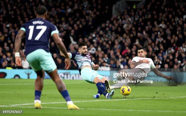 Neal Maupay of Brentford scores his team's first goal whilst under pressure from Cristian Romero of Tottenham Hotspur during the Premier League match...