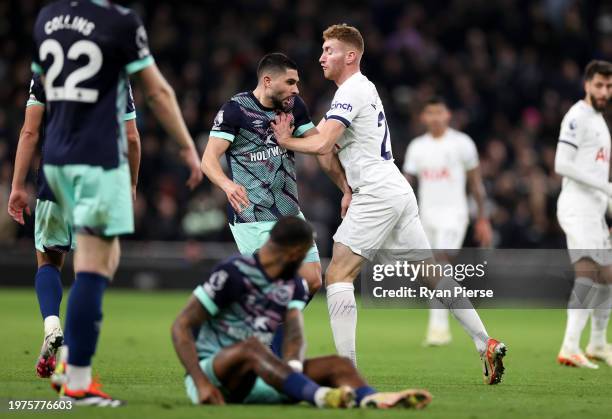 Dejan Kulusevski of Tottenham Hotspur clashes with Neal Maupay of Brentford leading to both players being shown a yellow card during the Premier...