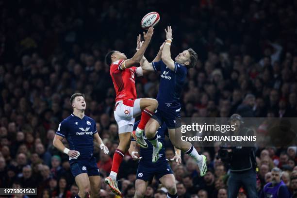 Wales' wing Josh Adams and Scotland's full-back Kyle Rowe jump for the ball during the Six Nations international rugby union match between Wales and...