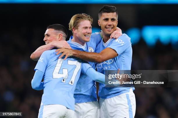 Kevin De Bruyne of Manchester City celebrates with Rodri and Phil Foden after a free-kick leads to his side's second goal during the Premier League...