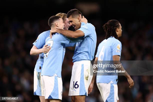 Rodri of Manchester City celebrates scoring his team's third goal with Phil Foden and Kevin De Bruyne during the Premier League match between...