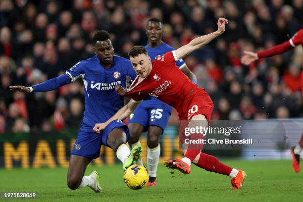 Diogo Jota of Liverpool scores his team's first goal whilst under pressure from Benoit Badiashile of Chelsea during the Premier League match between...