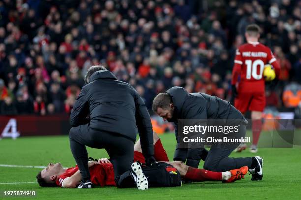 Diogo Jota of Liverpool receives medical treatment during the Premier League match between Liverpool FC and Chelsea FC at Anfield on January 31, 2024...