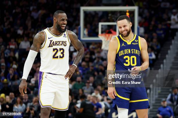 Stephen Curry of the Golden State Warriors and LeBron James of the Los Angeles Lakers joke around with one another during their game at Chase Center...