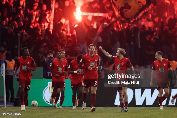 Players of 1. FC Kaiserslautern celebrate after teammate Filip Kaloc scores the team's third goal during the DFB cup round of 16 match between Hertha...